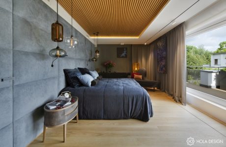 Luxurious bedroom with sleek concrete walls, warm wood ceiling, and modern lighting.