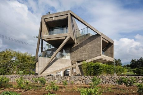 A unique modern concrete and glass structure with an angular and geometric design.