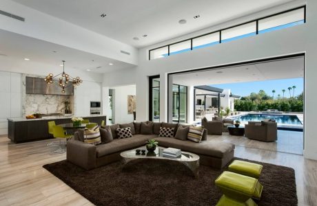 Sleek, modern living area with large windows, plush seating, and contemporary design.