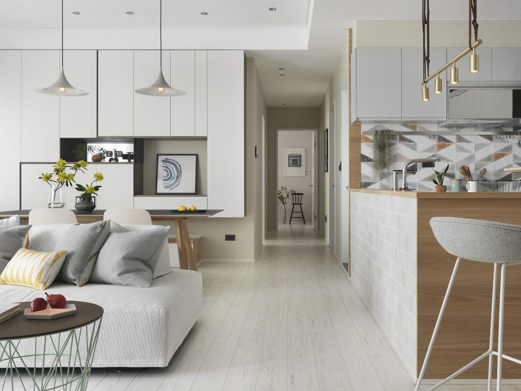 Stylish open-plan layout with neutral tones, modern lighting, and integrated kitchen.