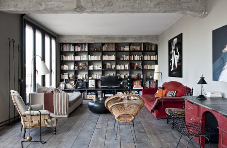 Cozy living room with large built-in bookshelves, vintage furnishings, and hardwood floors.