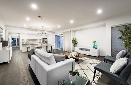 Spacious, open-concept living area with modern furniture, lighting, and decor elements.