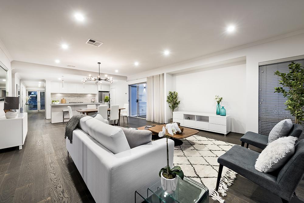 Spacious, open-concept living area with modern furniture, lighting, and decor elements.