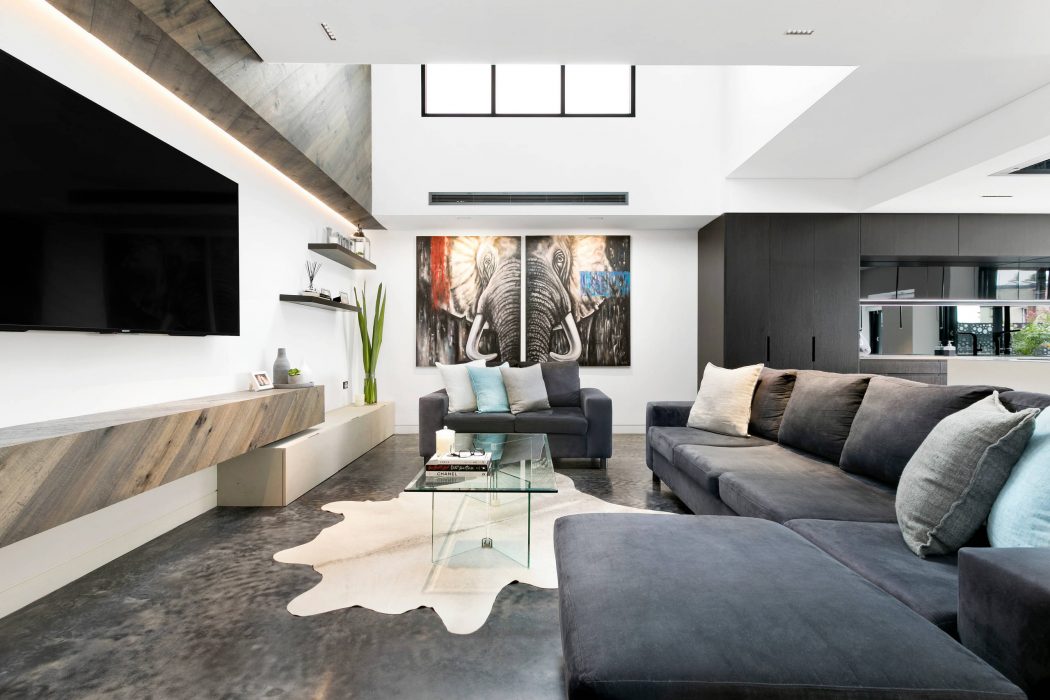 Spacious living area with modern decor, large sofa, and an elephant artwork as a focal point.