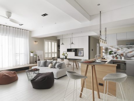 Spacious, open-concept living space with modern kitchen, wood and neutral tones.