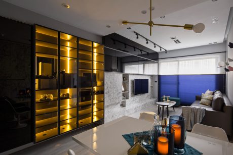 Sleek, modern apartment with backlit storage cabinets, marble wall accent, and ambient lighting.