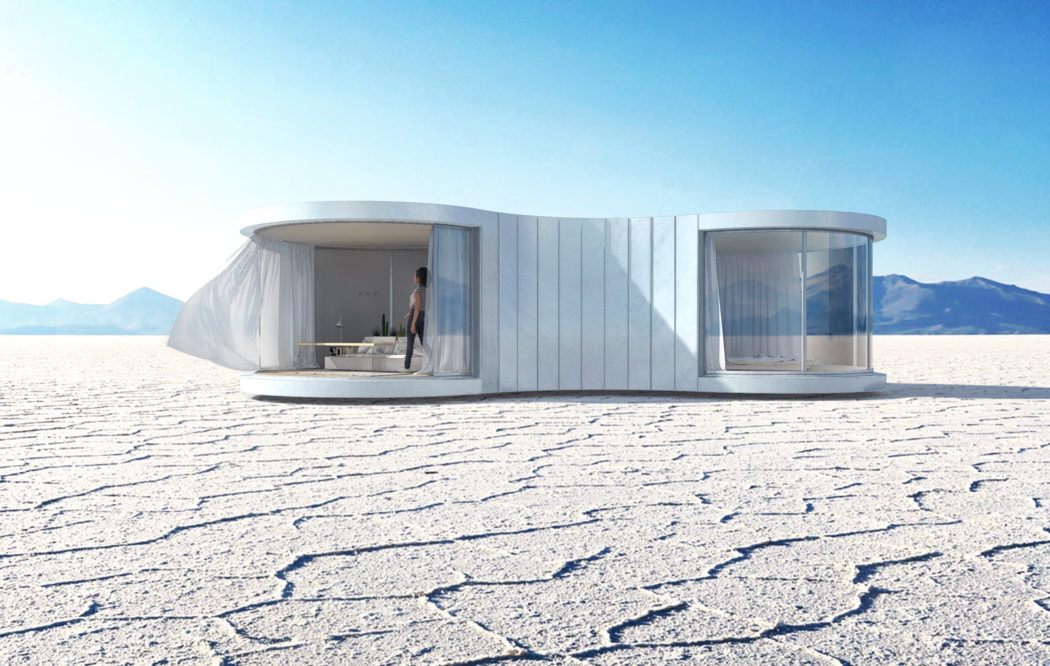 Sleek, minimalist modular housing structure with curved walls, glass panels, and mountain backdrop.