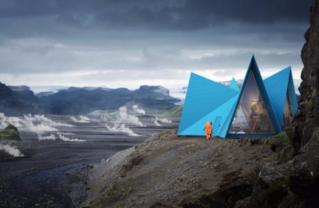 Striking blue geometric structures nestled in a rugged, mountainous landscape.