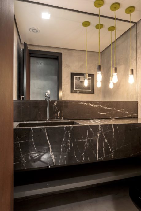 Elegant bathroom with sleek marble vanity, modern lighting, and minimal decor.