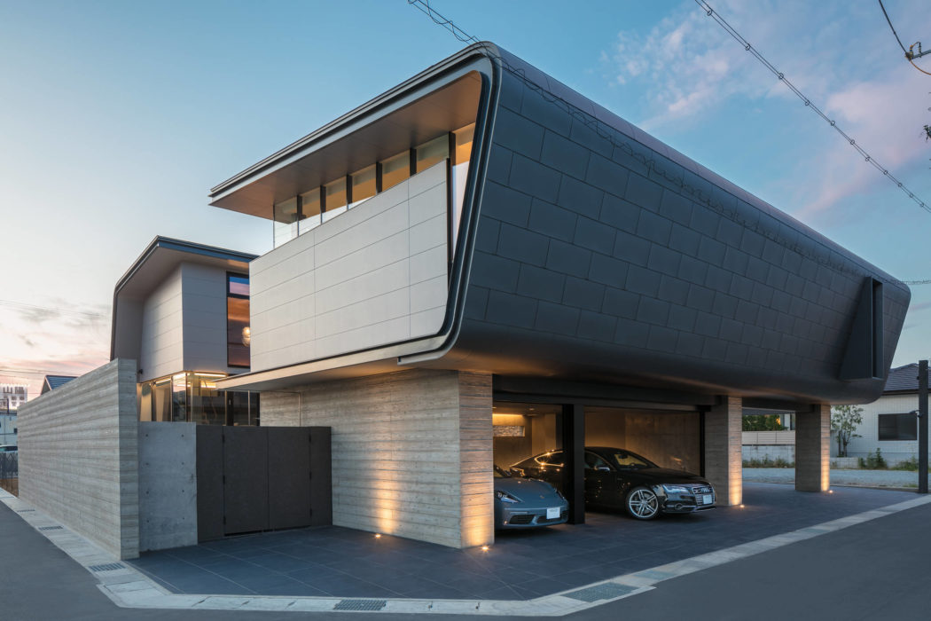 Contemporary architectural design with sleek lines, concrete and wood materials, and integrated garage space.