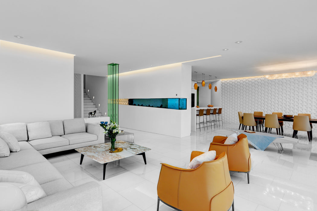 Spacious, modern interior with sleek furniture, lighting, and geometric patterns.
