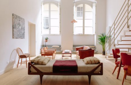 Elegant living room with arched windows, plush furnishings, and natural accents.