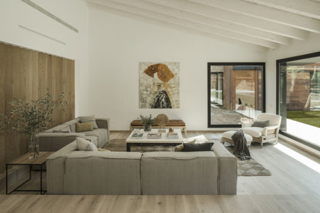 Warm, modern living room with wood, light colors, and artistic wall decor.