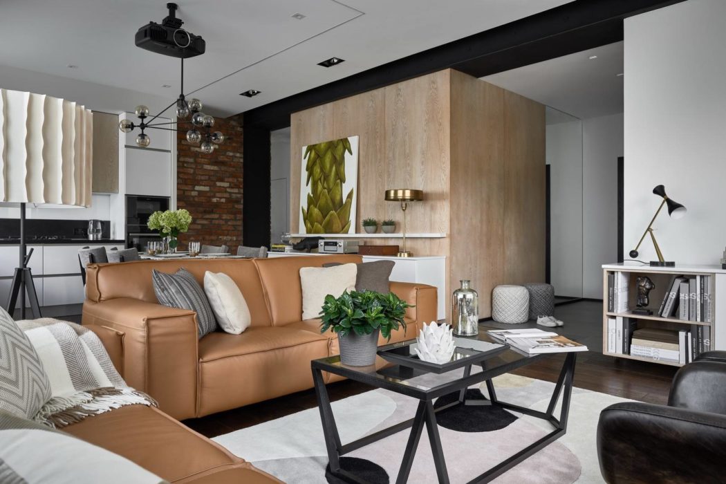 Sleek modern living space with a leather sofa, rustic wood accents, and bold lighting.