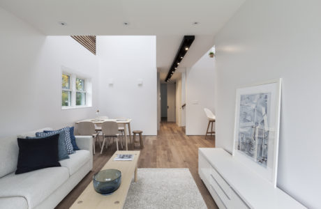 Bright, modern interior with minimalist furniture, hardwood floors, and abstract artwork.