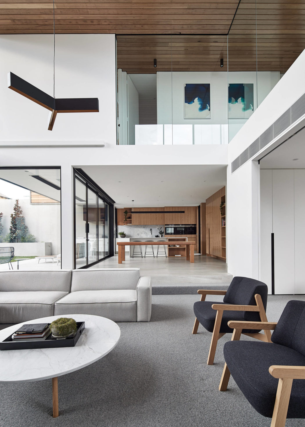 Sleek, modern interior with wood paneling, glass walls, and minimalist furniture.