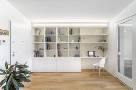Spacious modern home office with built-in shelving and clean minimalist design.