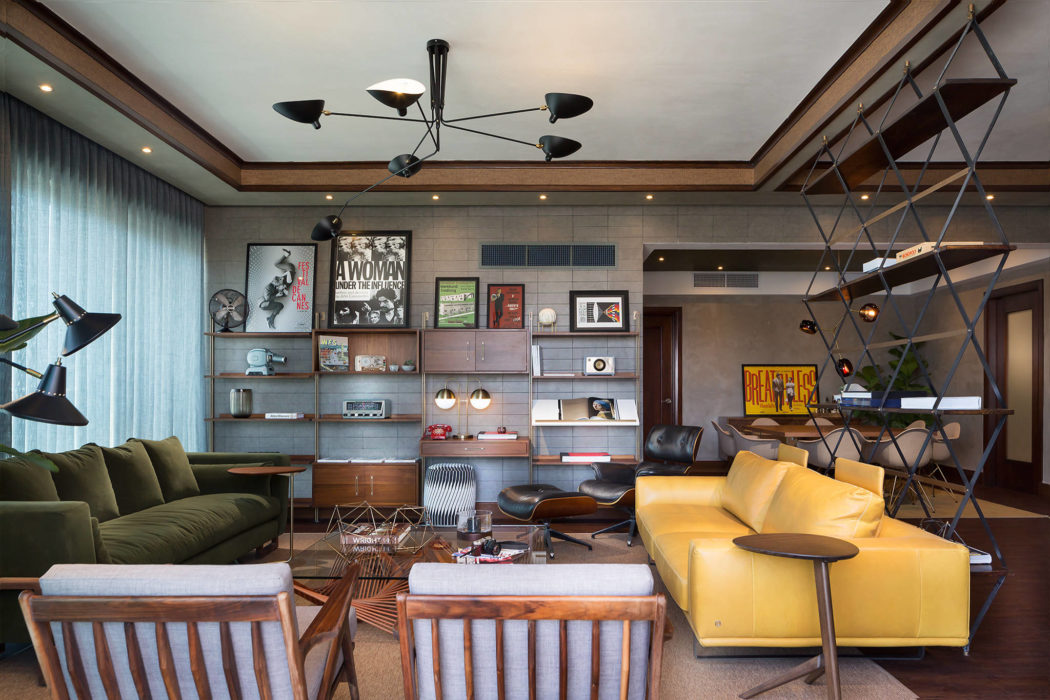 Stylish and eclectic living room with modern lighting, shelving, and industrial-inspired decor.