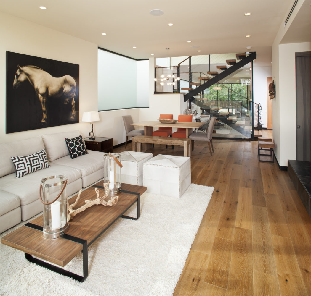 A well-designed modern living space featuring an open layout, wooden floors, and contemporary decor.