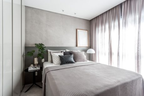 Sleek, modern bedroom with minimalist decor and large window offering natural light.