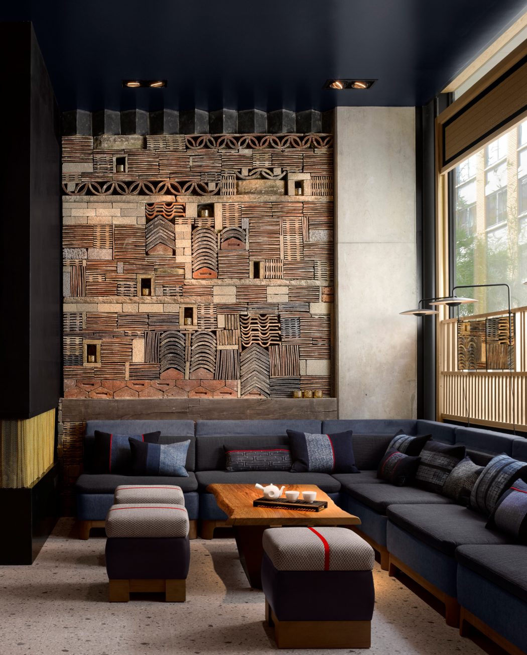 Chic lounge with textured wooden wall art and stylish seating.