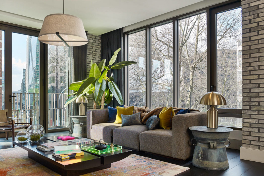 Modern living room with large windows and stylish decor.