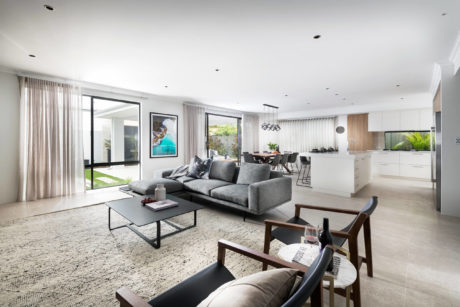 Spacious living room with neutral tones and large windows.