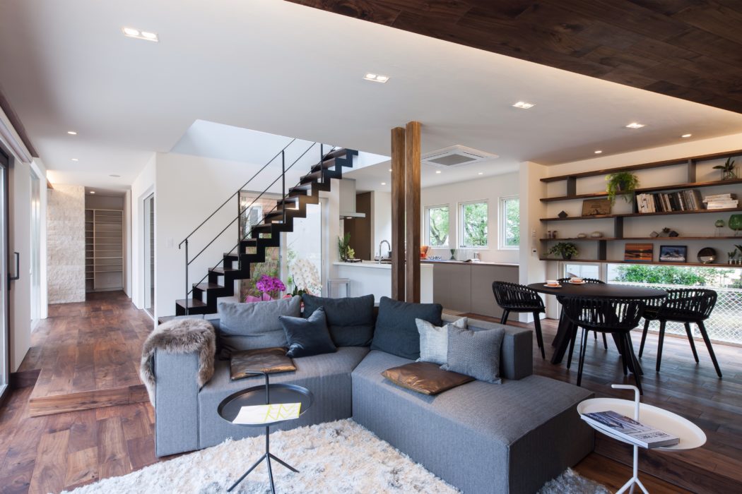 Spacious open-concept living area with sleek modern furnishings and wooden accents.