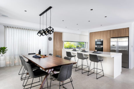 Sleek kitchen with wood accents, white cabinetry, and a geometric ch
