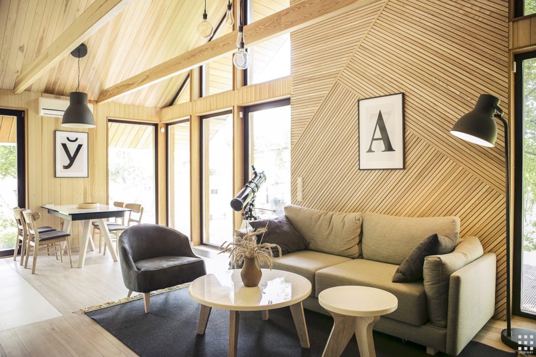 Warm, rustic interior with soaring wooden beams, cozy furniture, and sleek minimalist decor.