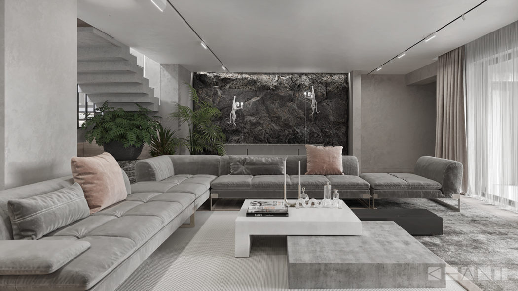 Minimalist living room with gray sectional sofa, concrete coffee table, and stone accent wall.