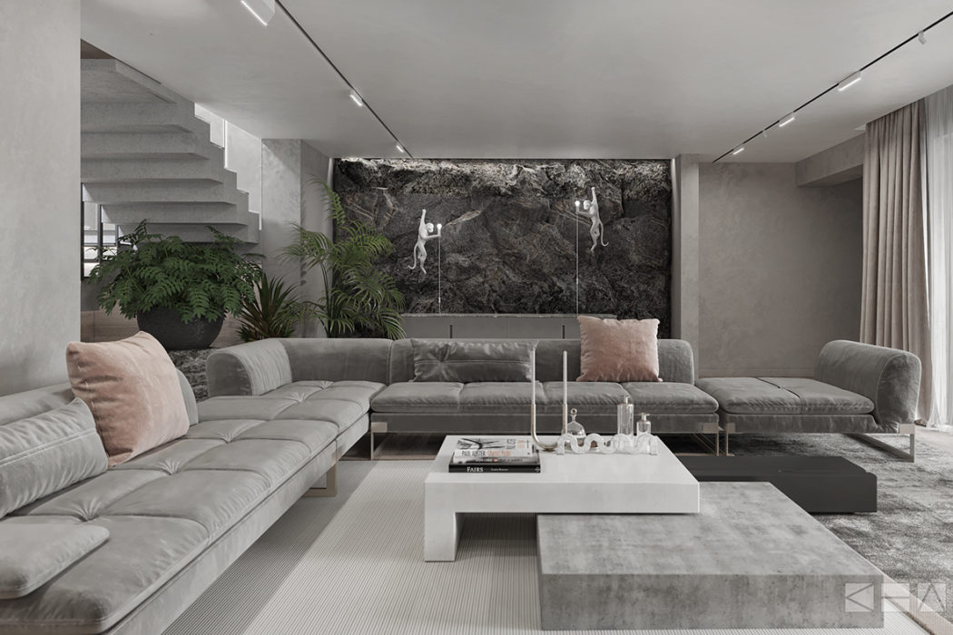 Minimalist living room with gray sectional sofa, concrete coffee table, and stone accent wall.