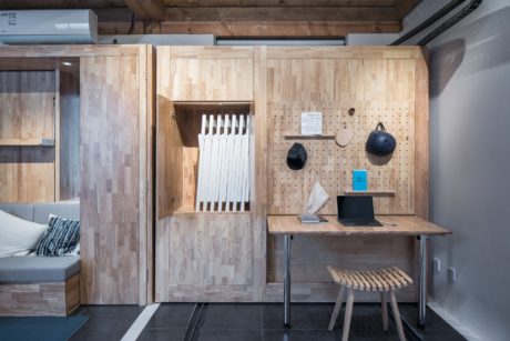 Rustic wooden interiors with built-in storage, workstation, and pegboard organization.
