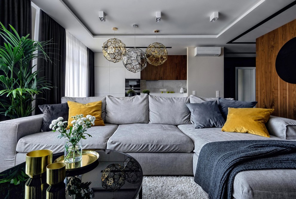 Sleek living room with modern lighting fixtures, plush gray sofa, and vibrant accents.