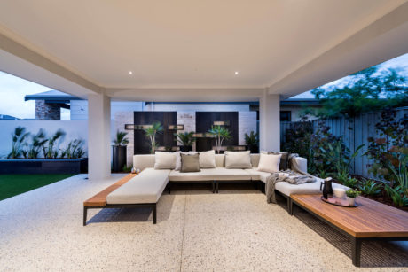 Spacious outdoor patio with sectional sofa and sleek water feature.