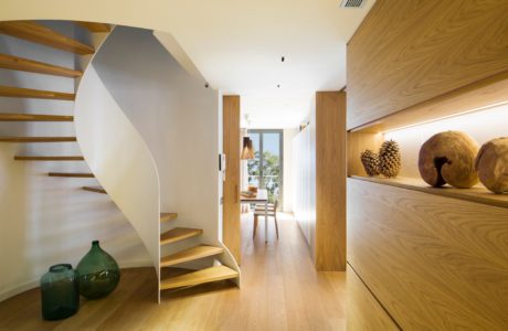 Contemporary wooden staircase with sleek white balustrade.