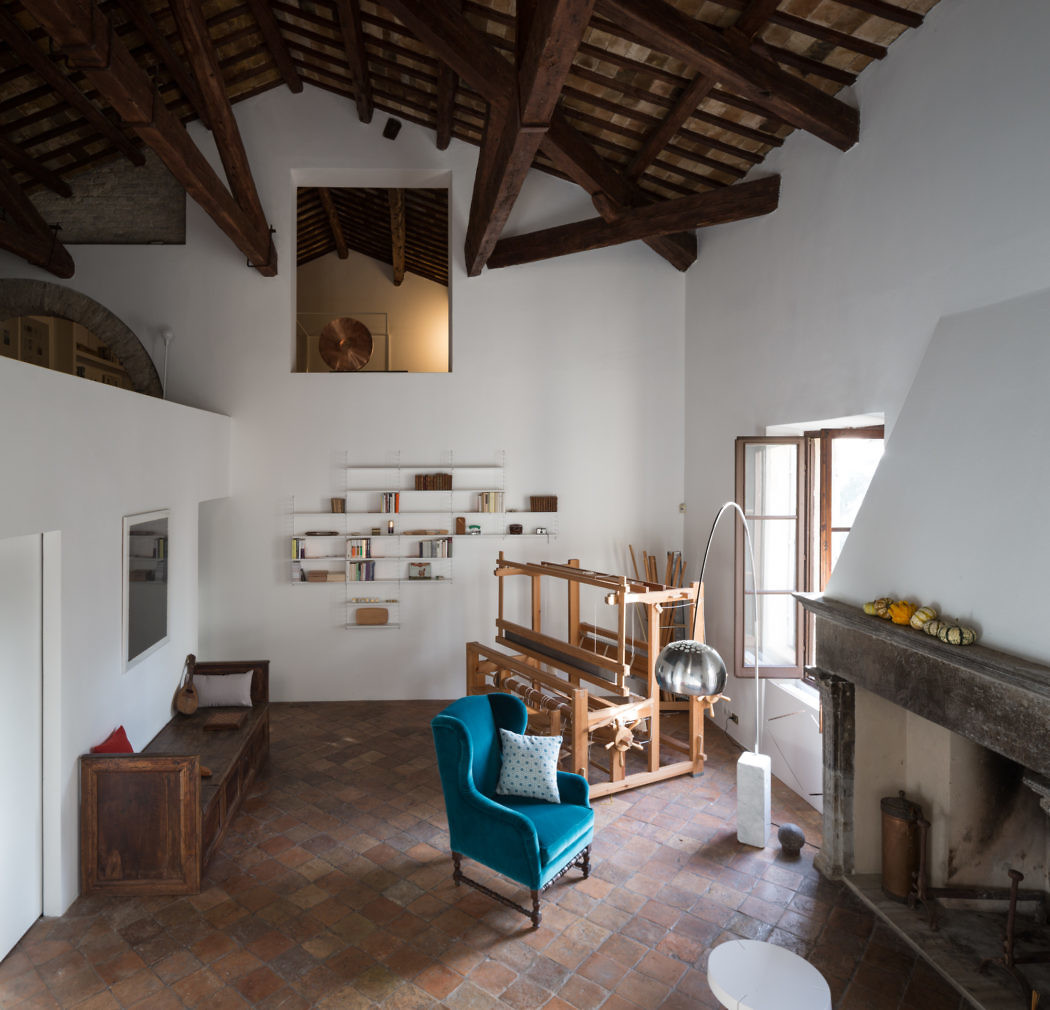 Rustic room with exposed beams, terracotta tiles, and a large