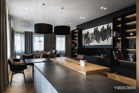 Chic interior with sleek fireplace, wooden table, and dark accents.