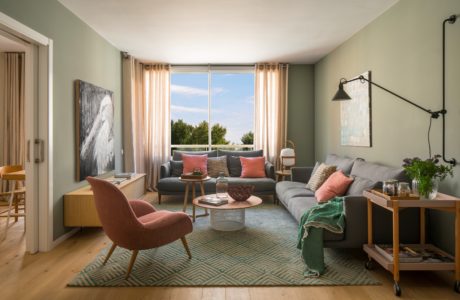 Contemporary living room with pastel walls and mid-century furniture.