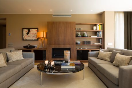 Contemporary living room with neutral tones and wood accents.