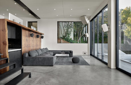 Contemporary living room with large windows and minimalist decor.