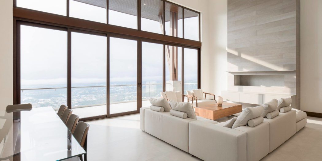 Contemporary living room with large windows and ocean view.