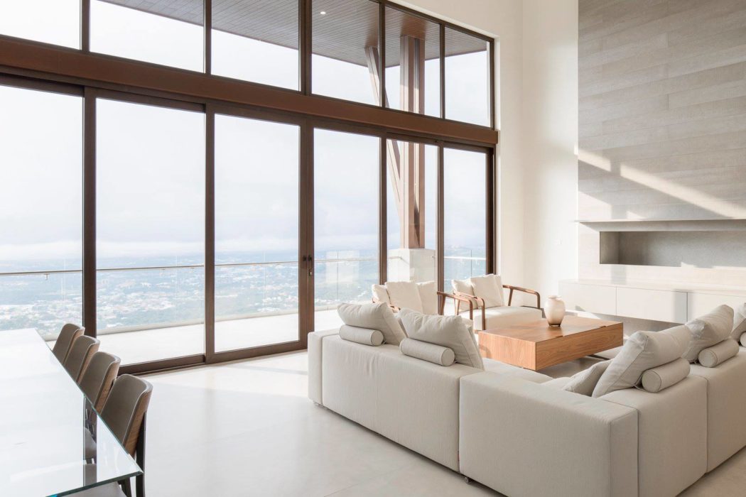 Contemporary living room with large windows and ocean view.