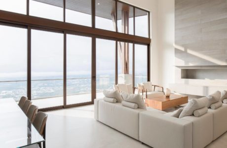 Contemporary living room with large windows and ocean view.