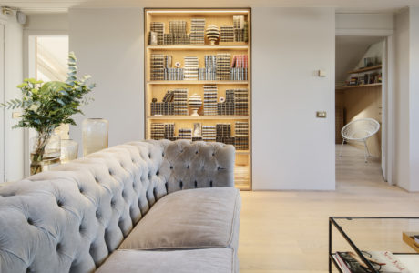 Elegant living room with a tufted sofa and built-in bookshelves