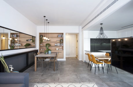 Modern kitchen and dining area with minimalist furniture and pendant lighting.