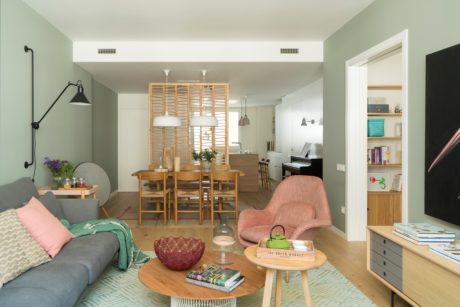 Contemporary living room with pastel tones and wooden furnishings.