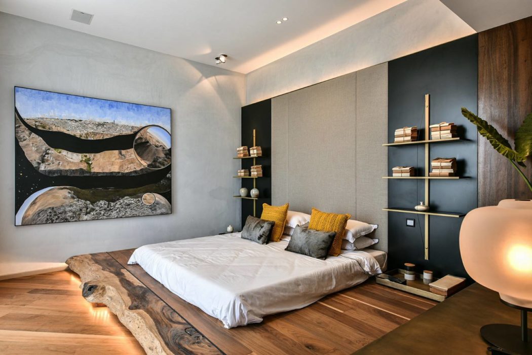 Stylish bedroom with wooden elements and large artwork.