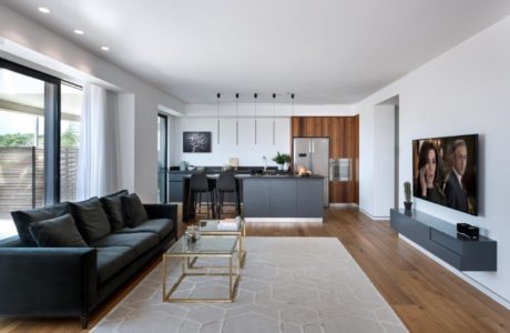 Contemporary living room with open kitchen design.