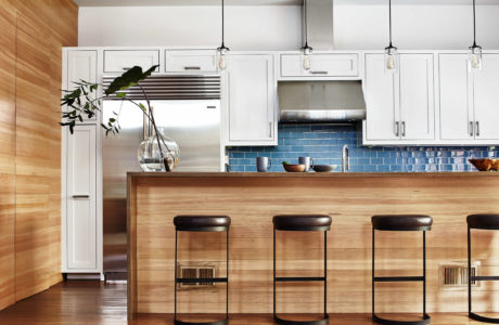 Contemporary kitchen with blue tile backsplash and wooden accents.